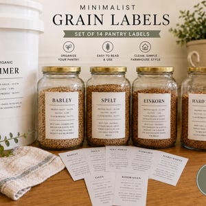 May include: A set of 14 pantry labels for grain storage, featuring white rectangular stickers with black text. The labels are displayed on four glass jars filled with grains and a large white bucket, alongside loose paper labels.