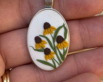 Botanical Clay Necklace - yellow coneflower on white background. Oval pendant with a simple minimalist design will last for years to come.