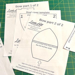 May include: White paper sewing templates labeled Bow part 1 of 2, Bow part 2 of 2, and Bowl cover template. The pages feature black outlines, arrows, and text instructions including once printed this line should be 4.5 inches wide.