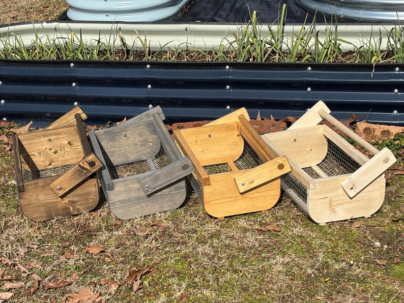 May include: Four wooden baskets with wire mesh bottoms and handles. The baskets are stained in different colors: natural wood, dark brown, gray, and light brown.