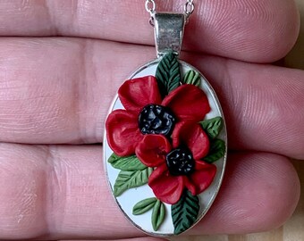 Bold red poppies on a beautiful white background. This is a showstopper and will get compliments. Lovely oval adds a vintage vibe.