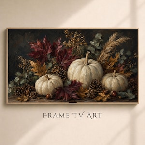 May include: A rectangular digital print titled FRAME TV ART featuring an oil painting style composition of three white pumpkins, dark red maple leaves, brown pinecones, acorns, and dried grasses arranged against a dark, moody background.