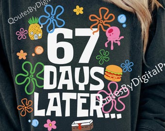 May include: Black sweatshirt with the text "67 DAYS LATER" in white, surrounded by colorful cartoon graphics including a pineapple, burger, and sea creatures. The sweatshirt has a crew neck.