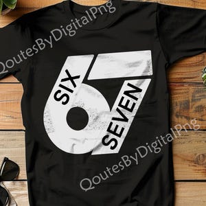 May include: Black t-shirt with a large white graphic design. The design features the word "SIX" above the number "67" in a bold, distressed font. The shirt is made of a soft material.