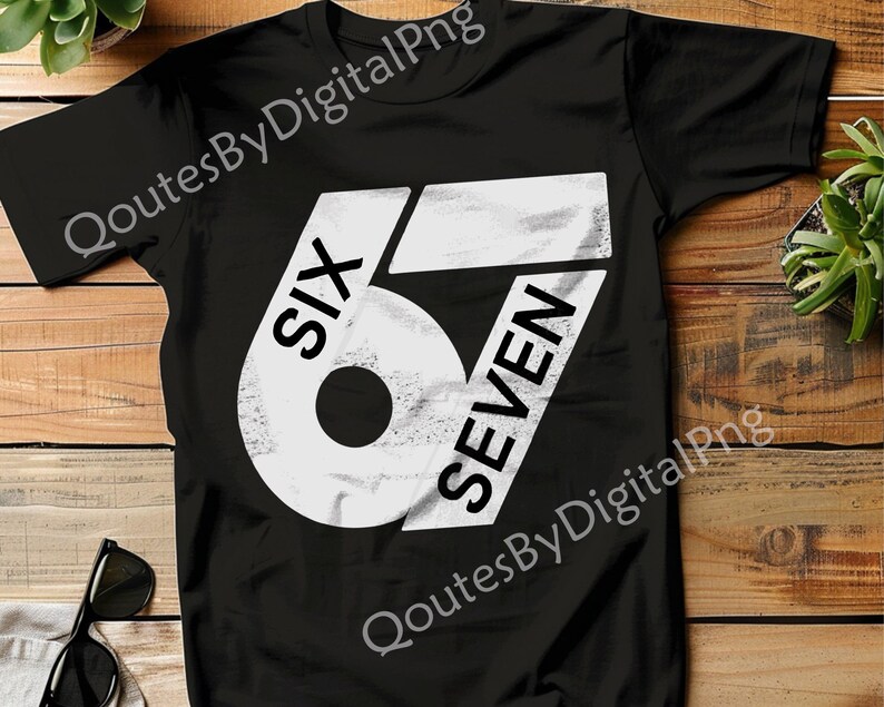 May include: Black t-shirt with a large white graphic design. The design features the word "SIX" above the number "67" in a bold, distressed font. The shirt is made of a soft material.