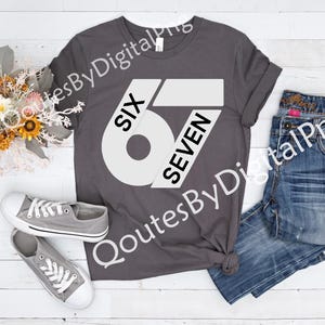 May include: A gray t-shirt with the text "SIX 67 SEVEN" in white. The shirt is paired with blue jeans and gray sneakers. A bouquet of flowers is also in the image.