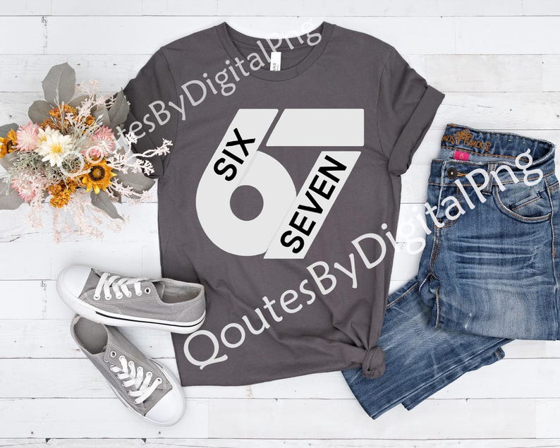 May include: A gray t-shirt with the text "SIX 67 SEVEN" in white. The shirt is paired with blue jeans and gray sneakers. A bouquet of flowers is also in the image.