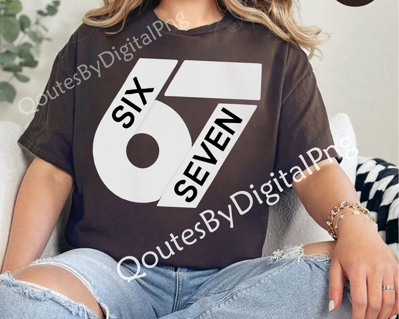 May include: A brown t-shirt with the text "SIX 6 SEVEN" in a bold, white font. The shirt is a casual style, with a round neckline and short sleeves. The design is centered on the front of the shirt.