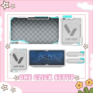 May include: A digital clock showing "06:00" with a blue gradient background, and two "LIFE TEST" graphics. The design includes a frame with a quilted pattern, and the text "ONE CLICK SETUP". The color scheme is white, grey, and light blue.