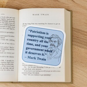 May include: A blue sticker with a quote by Mark Twain, featuring his portrait. The quote reads: "Patriotism is supporting your country all the time, and your government when it deserves it."