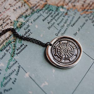 adventurer. a silver wax seal compass travel necklace