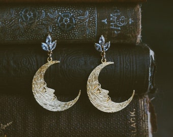 radiant moon. a pair of golden crescent moon and cubic zirconia leaf vintage art deco inspired earrings