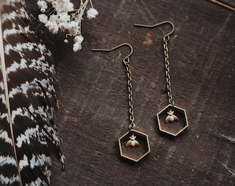 the beekeeper. a pair of modern geometric boho nature inspired brass hexagon honeycomb and tiny bee drop earrings