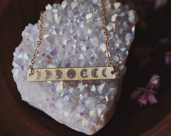 lunar. a simple boho celestial brass moon phase bar necklace
