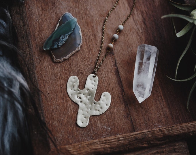 a hand stamped brass saguaro cactus pendant statement necklace with amazonite beaded chain desert sky