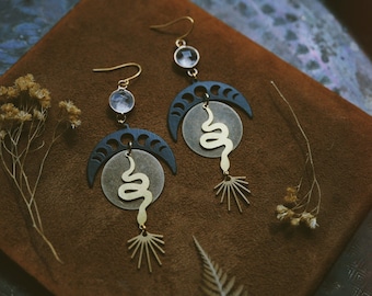 golden snake. a pair of bohemian celestial mixed metal snake and quartz statement earrings