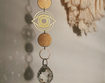 window to the soul. a bohemian eye and geometric crystal teardrop rainbow maker sun catcher