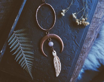 wilderness moon. a bohemian antiqued copper moon and carved bone feather statement necklace