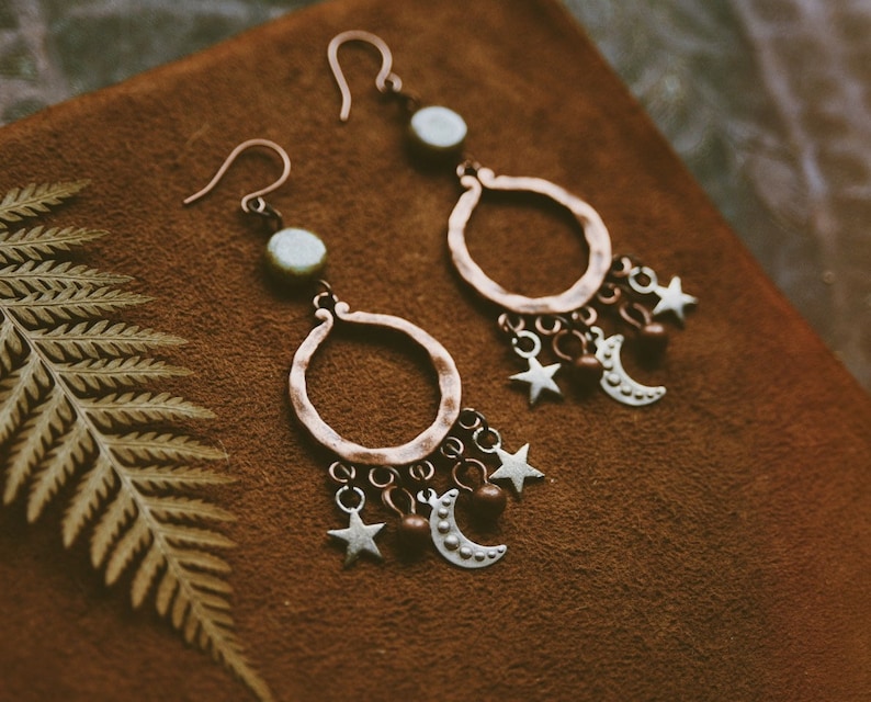 Celestial beauties made from antiqued copper and silver charms, glass beads and simple copper earwires. They measure approximately 2.5” long.