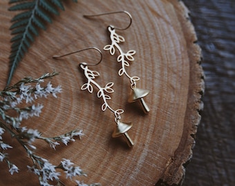 foraged. a pair of boho forest inspired whimsical woodland nature mushroom and vine leafy branch gold plated matte brass earrings