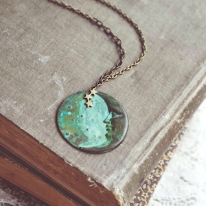 la luna necklace in green patina. a bohemian crescent moon face and star constellation statement necklace