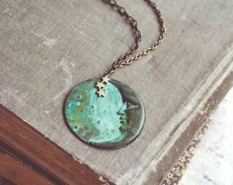 la luna necklace in green patina. a bohemian crescent moon face and star constellation statement necklace