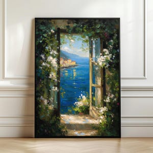 May include: An oil painting in a black frame shows a coastal vista seen through an open doorway. The bright blue sea and sky contrast with the green foliage and white flowers around the opening. A small town is visible in the distance.