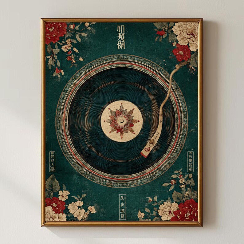 May include: A framed art print featuring a vintage record player design. The artwork has a teal background with floral accents in red and white. The record itself is dark blue with a detailed center design. Gold frame.