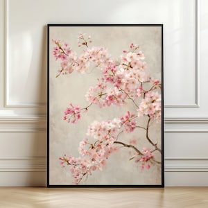 May include: A vertical rectangular wall art print featuring a detailed illustration of delicate pink cherry blossom branches set against a neutral, textured beige background, enclosed within a thin black frame.