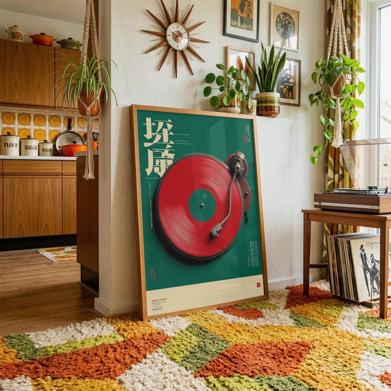 May include: A framed vertical poster featuring a vibrant red vinyl record on a dark green background. The artwork includes white Japanese text characters on the left side and a minimalist layout. The poster is displayed in a wooden frame.