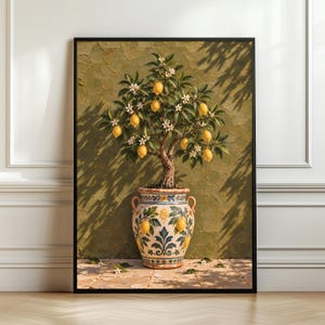 Può includere: Una stampa d'arte incorniciata raffigurante un albero di limoni in vaso con frutti gialli e fiori bianchi. L'albero è posto in un'urna di ceramica decorativa con motivi dipinti in blu e giallo su una parete verde oliva strutturata.