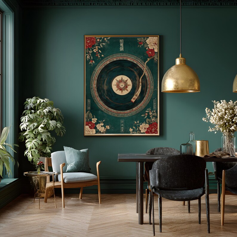 May include: A framed wall art print featuring a vintage record player design with floral accents in red and white on a teal background. The artwork is displayed in a room with a gold pendant light and a dining table.