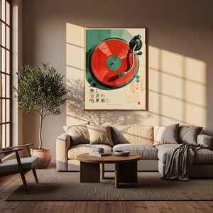 May include: A framed wall art print featuring a top-down view of a turntable with a vibrant red vinyl record. The artwork includes dark green accents and Japanese text characters printed in black and red, displayed in a neutral-toned living room.