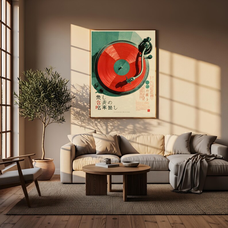 May include: A framed wall art print featuring a top-down view of a turntable with a vibrant red vinyl record. The artwork includes dark green accents and Japanese text characters printed in black and red, displayed in a neutral-toned living room.