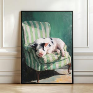 May include: A framed artwork depicts a relaxed pig resting on a green and white striped armchair. The pig is white with black spots and a pink snout. The background is a solid green color.