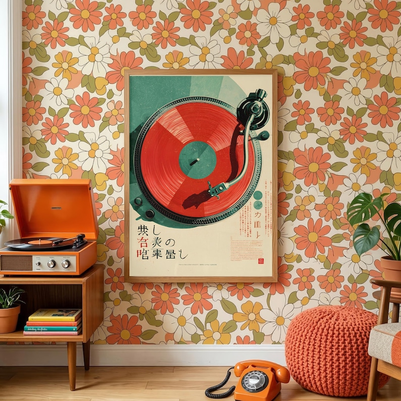 May include: A framed poster featuring a red vinyl record on a turntable, displayed on a wall with a retro floral pattern of orange, yellow, and white flowers. The poster includes Japanese text and a graphic of a record player tonearm in black.