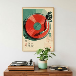 May include: A rectangular wall poster featuring a graphic illustration of a turntable with a vibrant red vinyl record. The design includes dark teal accents and Japanese text characters. Below the poster sits a wooden record player and a plant.