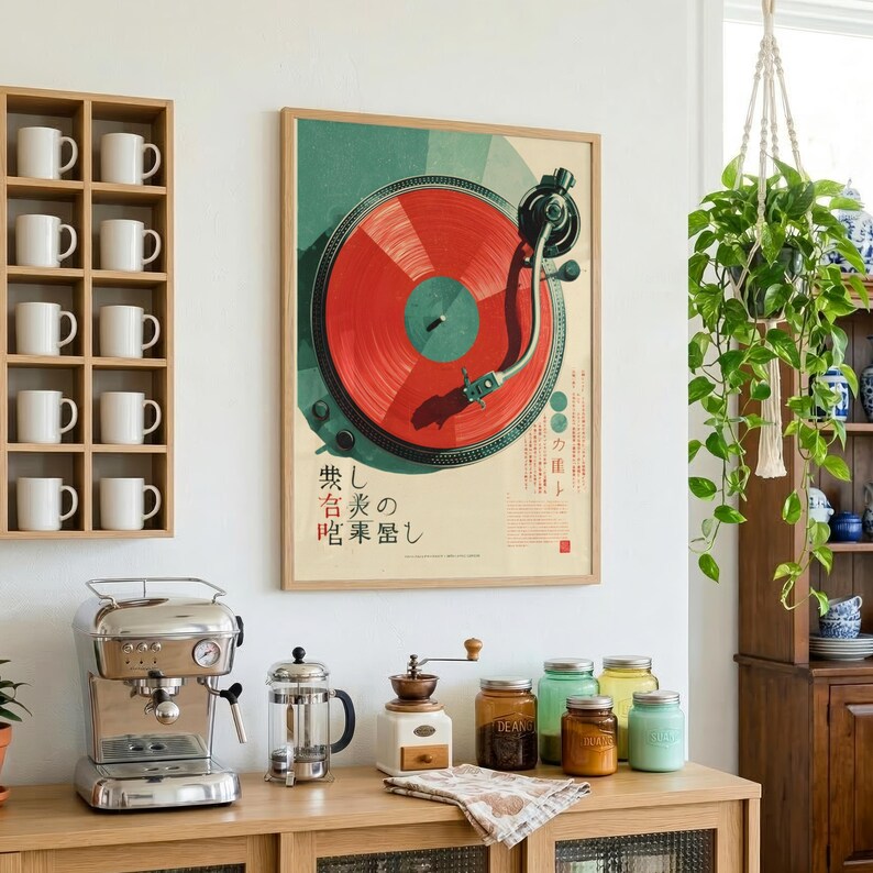 May include: A rectangular wall poster featuring a graphic illustration of a red vinyl record on a turntable with Japanese text. The poster is displayed on a white wall next to a wooden shelf containing ten white mugs and a hanging green plant.