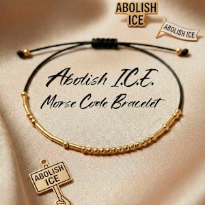 May include: A gold-coloured Morse code bracelet with the text "Abolish I.C.E. Morse Code Bracelet". The bracelet is on a black cord. Also shown are three gold-coloured pins with the text "Abolish ICE".