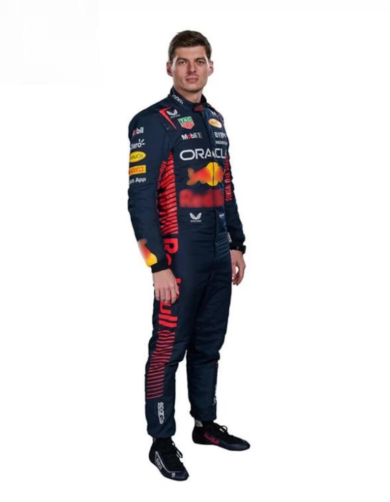 May include: A navy blue racing suit with red and yellow detailing. The suit displays sponsor logos and the Oracle logo. The Red Bull logo is visible on the chest and leg. The suit is worn with black trainers.