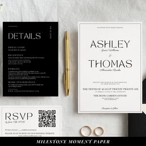 May include: Elegant wedding stationery set featuring a black and white invitation, RSVP card, and details card. A gold pen and two gold wedding bands are also present. The invitation includes the names Ashley and Thomas.
