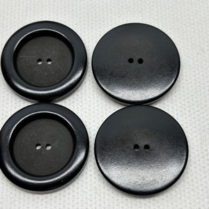Large Satin Black buttons shiny rim  Lot of 4  Buttons 2 hole. Buttons as shown in picture  beautiful-  1- 5/16&quot;  (34.2mm across) .