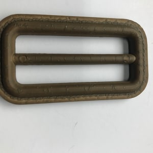 Light Tan / Brown Buckle  - Overall size (2 9/16&quot; long by 1 3/8&quot; wide) . Slot  1  7/8&quot; long.x 5/16&quot; wide. Imitation Leather.