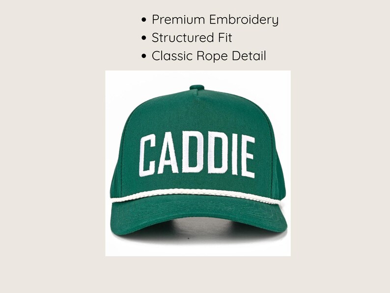 May include: A forest green baseball cap featuring the word CADDIE embroidered in white capital letters across the front. The cap has a structured fit and a white braided rope detail running horizontally across the base of the crown.