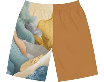 May include: A pair of shorts featuring a split design. One side showcases an abstract landscape in shades of blue, gray, yellow, and beige. The other side is a solid, warm brown color. The shorts have a comfortable, casual style.