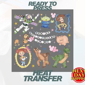 May include: A heat transfer sheet featuring Toy Story characters including Buzz Lightyear, an alien, Woody, Slinky Dog, Hamm, Jessie, Bullseye, and Rex. The text reads READY TO PRESS, YOU'VE GOT A FRIEND IN ME, and HEAT TRANSFER.
