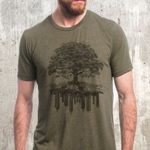 May include: A green t-shirt with a black and white graphic of a tree with roots growing into a city skyline.