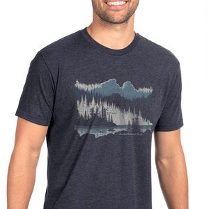 May include: A dark blue heather t-shirt with a graphic print of a mountain range and a lake with the text "Alaska National Park".
