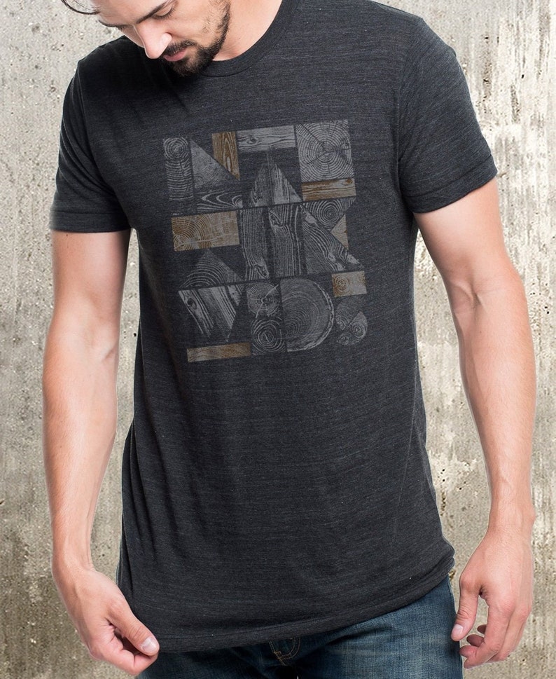 May include: A dark grey t-shirt with a geometric pattern of wood grain in shades of brown and grey.