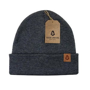 May include: A gray knitted beanie with a brown leather patch that says "Black Lantern" in black text. The patch also has a black logo of a stylized flame.